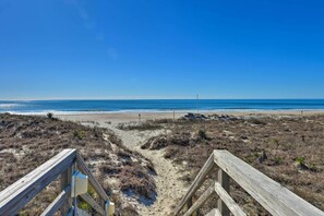 A wooden boardwalk leading to a beach with clear skies. - Emerald Isle Resort-Style Condo: Walk to Beaches! (Emerald Isle)