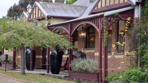 A Victorian-style building with a brick facade, arched windows, and a covered porch. - The Eaglehawk Country House Hotel Maldon (Maldon)