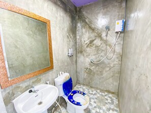 A bathroom with a sink, mirror, toilet, and shower. - Delighted Bangkok Hotel (Bangkok)