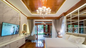 A bedroom with a large bed, a TV on the wall, and a view of the garden. - Chiang Mai's Best Garden Paradise Villa, A/C, Free Breakfast, Pool, Rental Van (Nam Phrae)