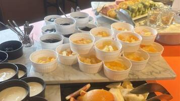Uma mesa de buffet com diversos alimentos e recipientes.