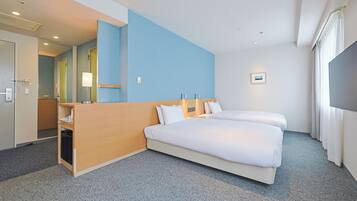 A hotel room with a large bed, a wooden desk, a mirror, and a TV.
