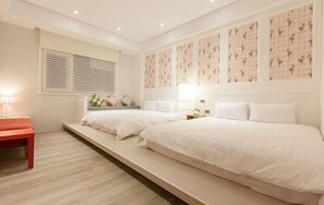 A bedroom with two beds, a bench, and a window with blinds. - Lanven Art House (Hualien City)