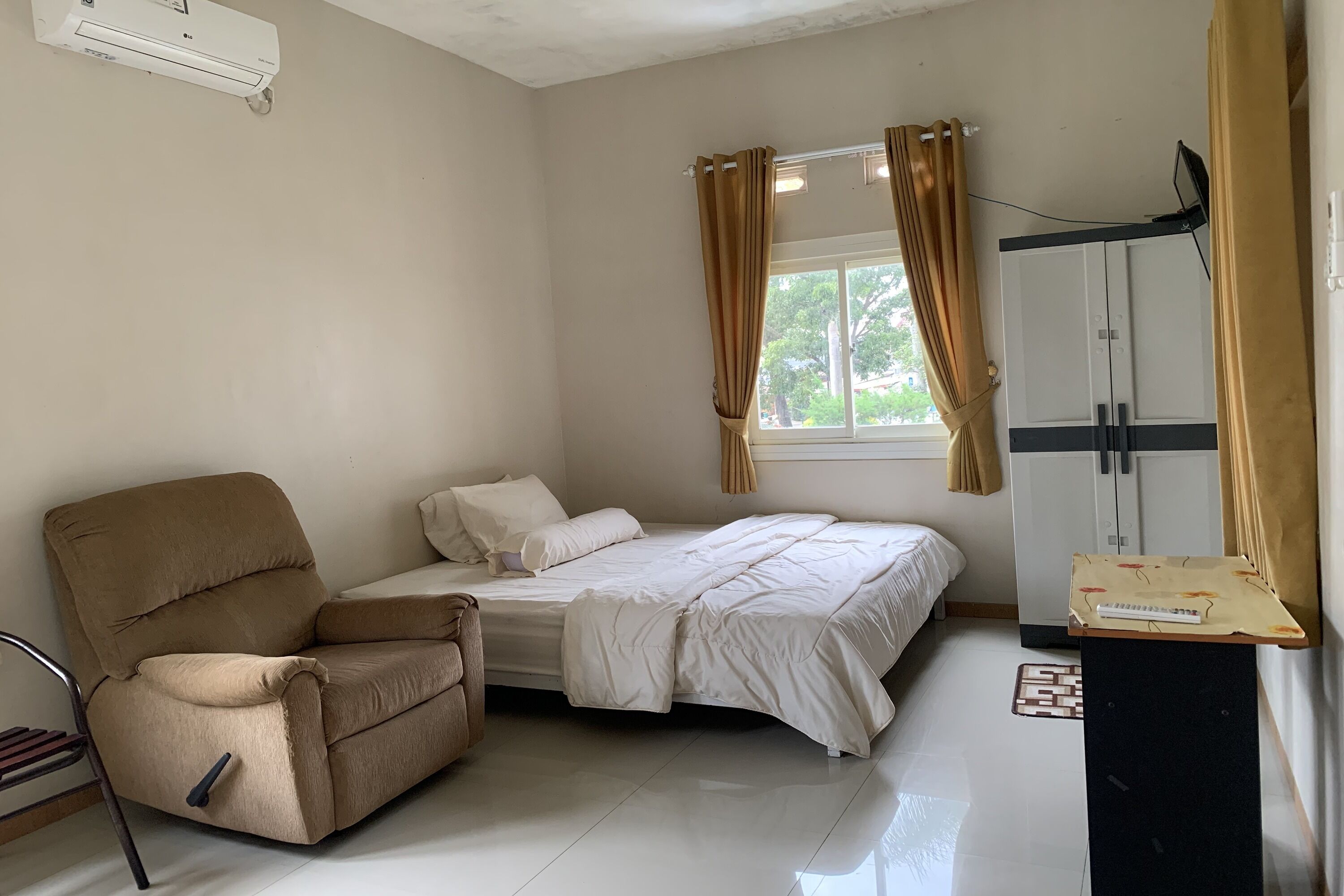 A room with a bed, a sofa, a desk, and a wardrobe.
