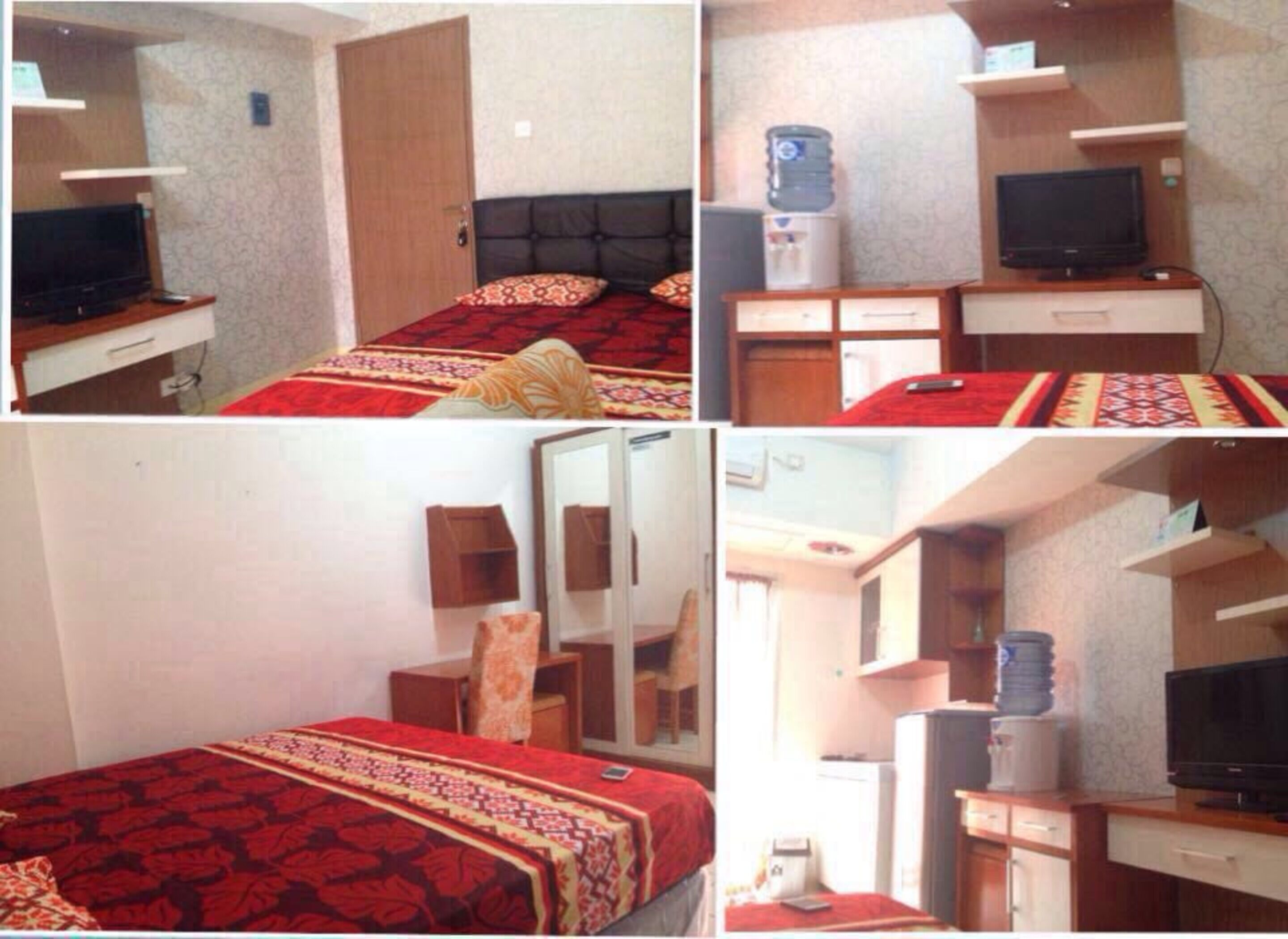 Une chambre d’hôtel équipée d’un lit, d’une télévision, d’un distributeur d’eau, d’un miroir et d’un bureau avec une chaise.