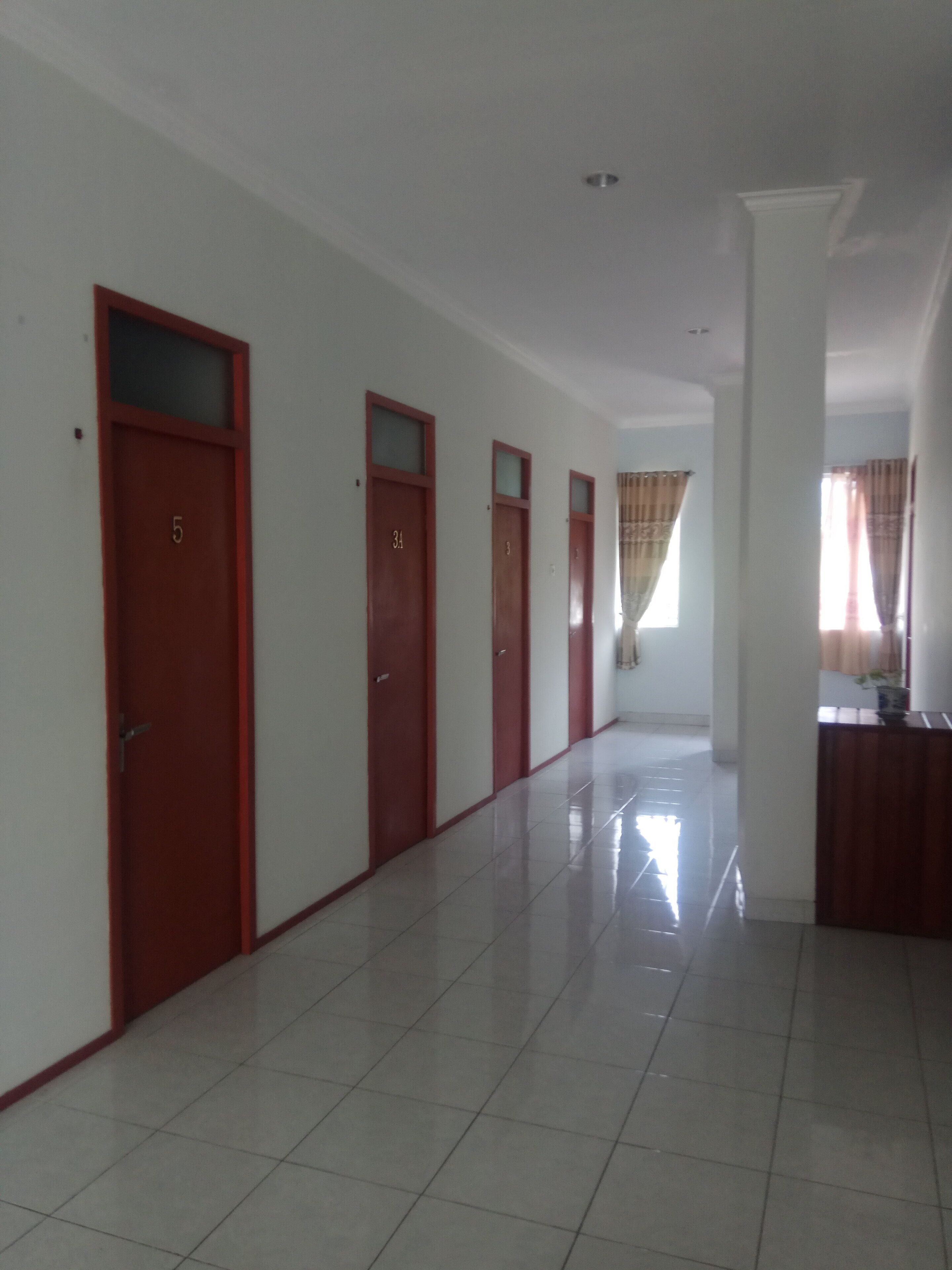 A hallway with doors numbered 5, 34, and 3, leading to rooms.
