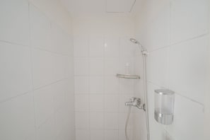 A shower with a handheld showerhead, a wall-mounted faucet, and a soap dispenser. - The Jarrdin by Bethania Pro by Zuzu (Bandung)