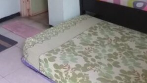 A bedroom with a bed, a door, and a small window. - Griya Dua Putra Jaya I (Bojonegoro)