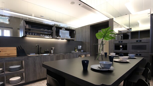 A modern kitchen with a central island, built-in appliances, and a large mirror. - ST Signature Jalan Besar, SHORT OVERNIGHT, 8 hours: 11:59PM-8AM (Singapore)