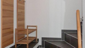 A staircase with wooden steps and a chair at the bottom. - Seetiger (Krummhoern)