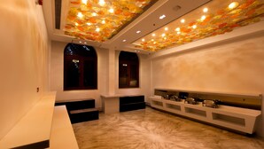 A modern interior with a marble floor, white walls, and a ceiling with a light fixture. - Hotel MBC Citadel Nashik (Nashik)