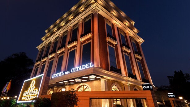 A hotel with a classic architectural design, featuring large columns and arched windows. - Hotel MBC Citadel Nashik (Nashik)