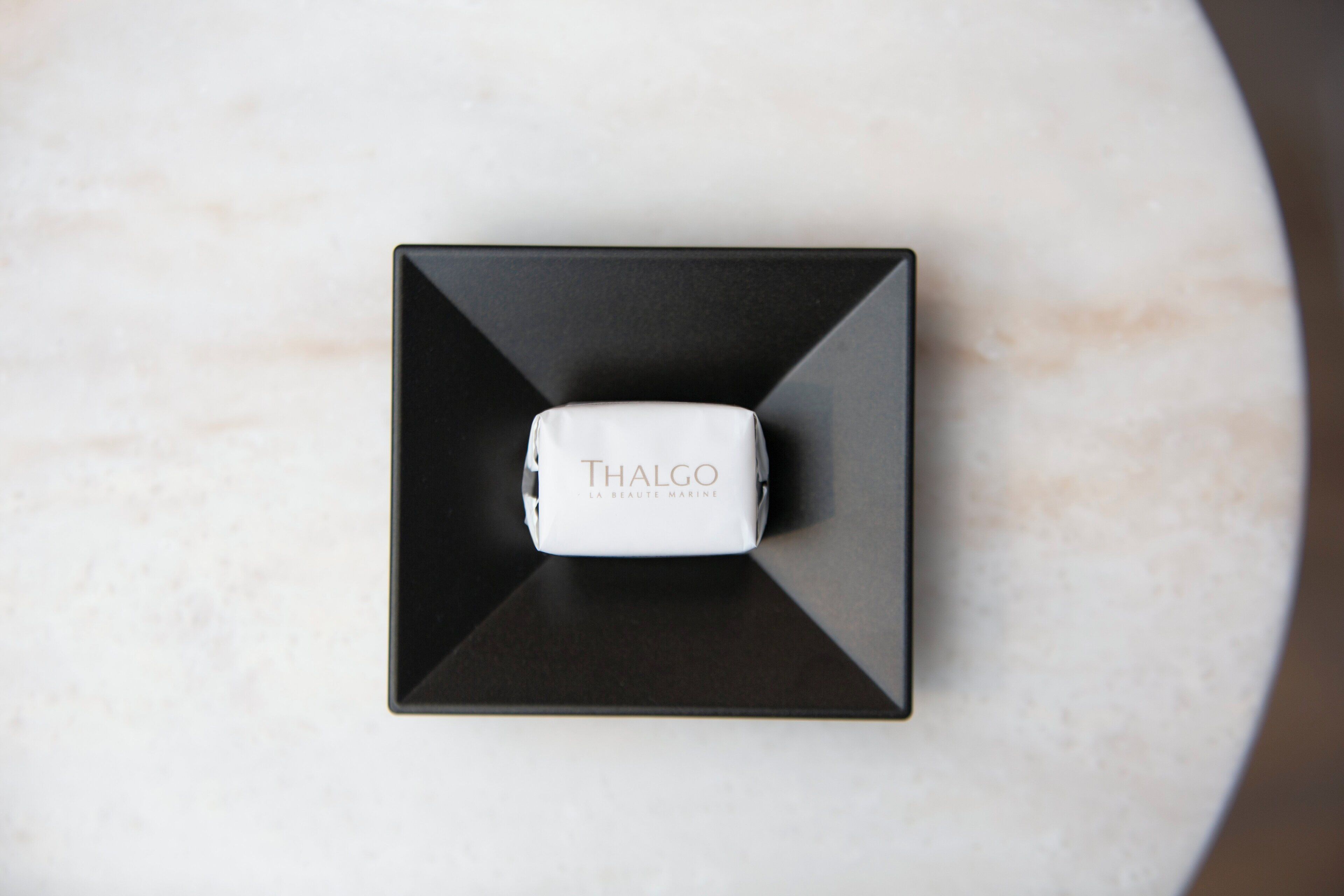 A Thalgo La Beauté Marine product on a black and white marble surface.