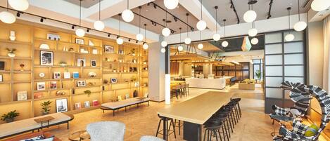 A modern interior with a long communal table, several bar stools, and a unique zebra-striped chair.