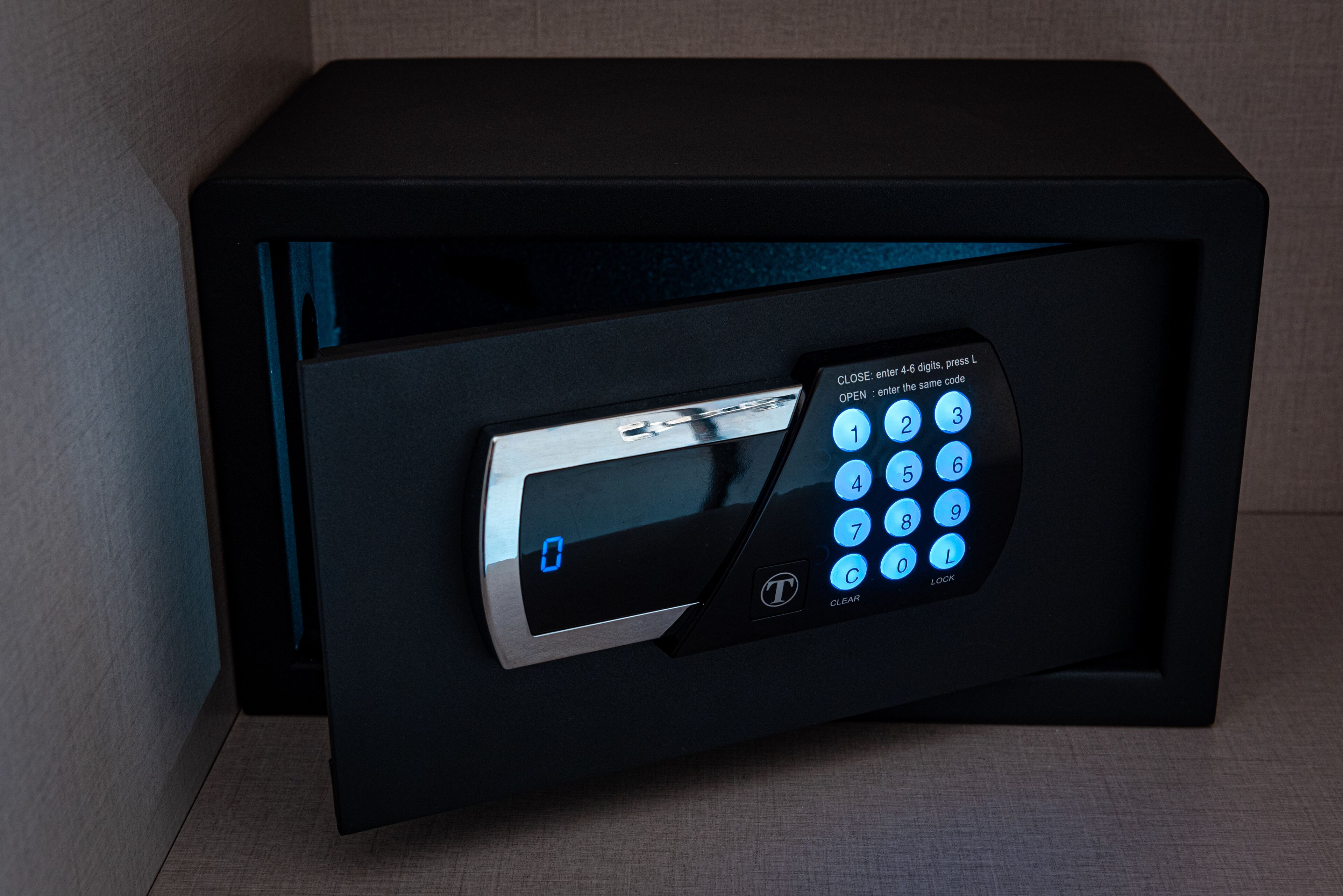 A black safe with a digital keypad and a small screen.
