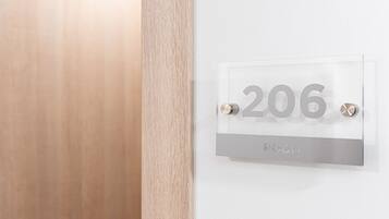 A clear room number sign with the number 206 and the word "ROOM" below it, indicating the room number.