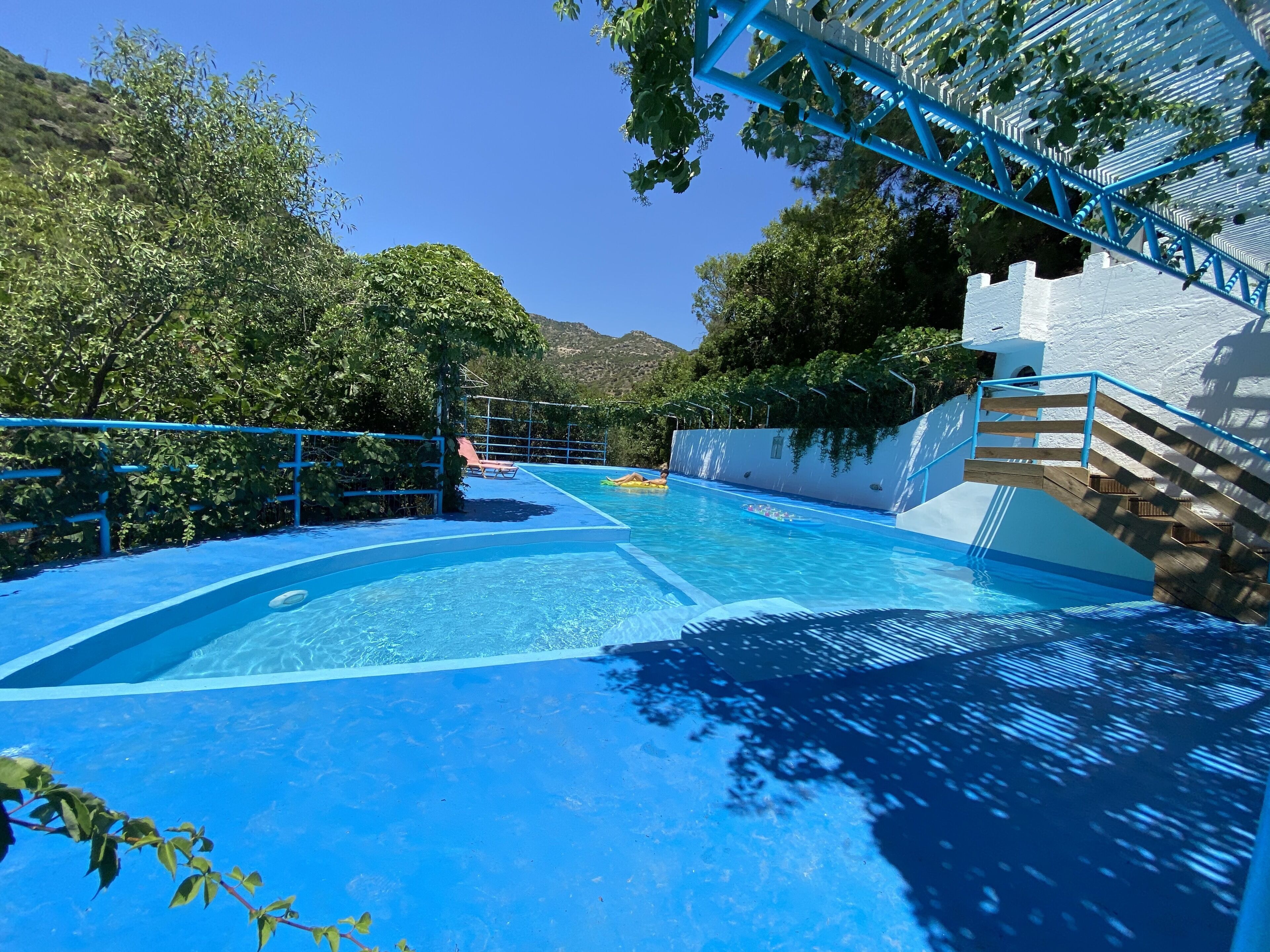 Alberca al aire libre, sombrillas en la alberca y camastros 