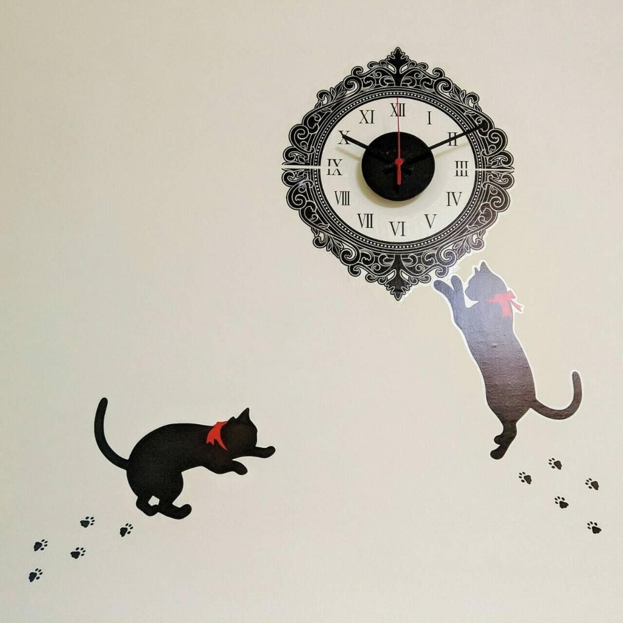 A wall clock with Roman numerals and a decorative frame.