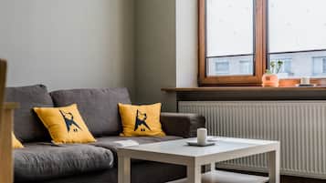 City Apartment | Living area | 107-cm flat-screen TV with cable channels, TV, heated floors