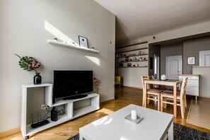 City Apartment | Living area | 107-cm flat-screen TV with cable channels, TV, heated floors - New town apartments (Vilnius)