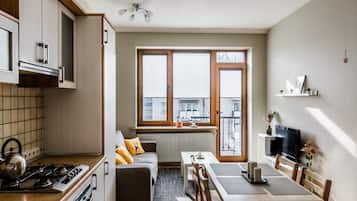 City Apartment | Living area | 107-cm flat-screen TV with cable channels, TV, heated floors