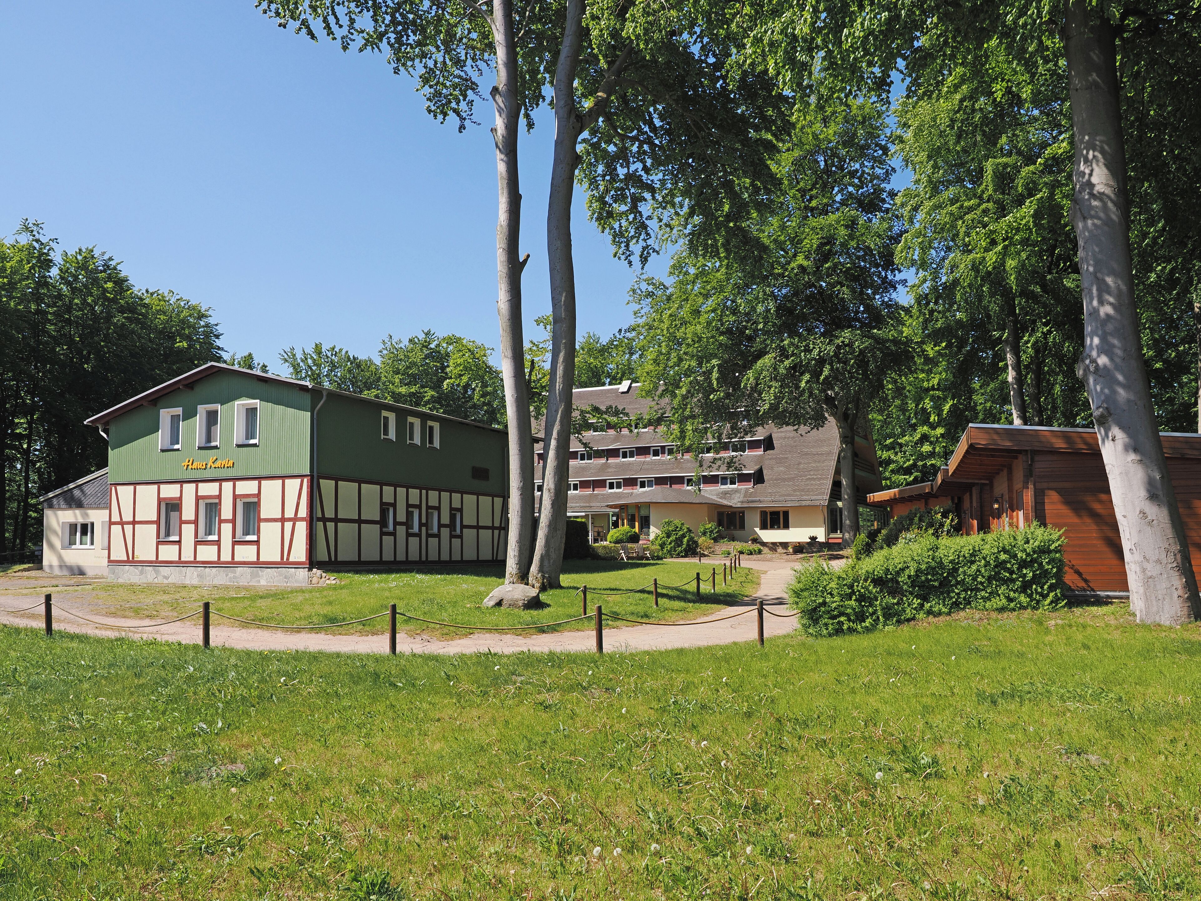 A traditional building with a green facade and a sign reading "Hans Kautz".