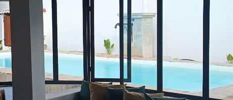 Outdoor pool, open 9:00 AM to 8:00 PM, pool loungers