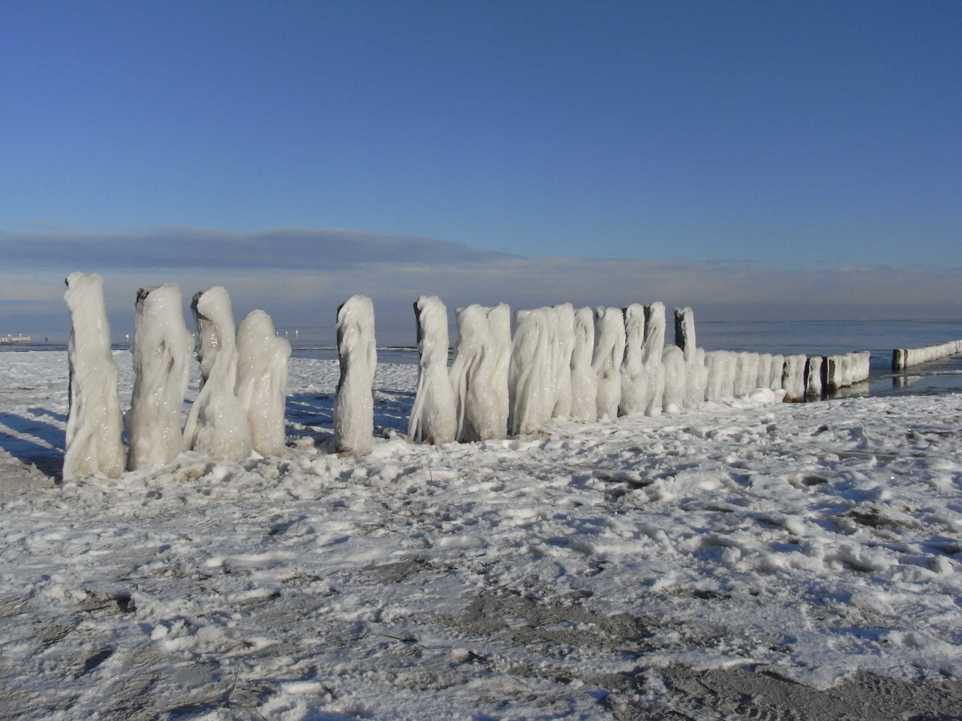 A frozen landscape with ice formations and a clear sky.