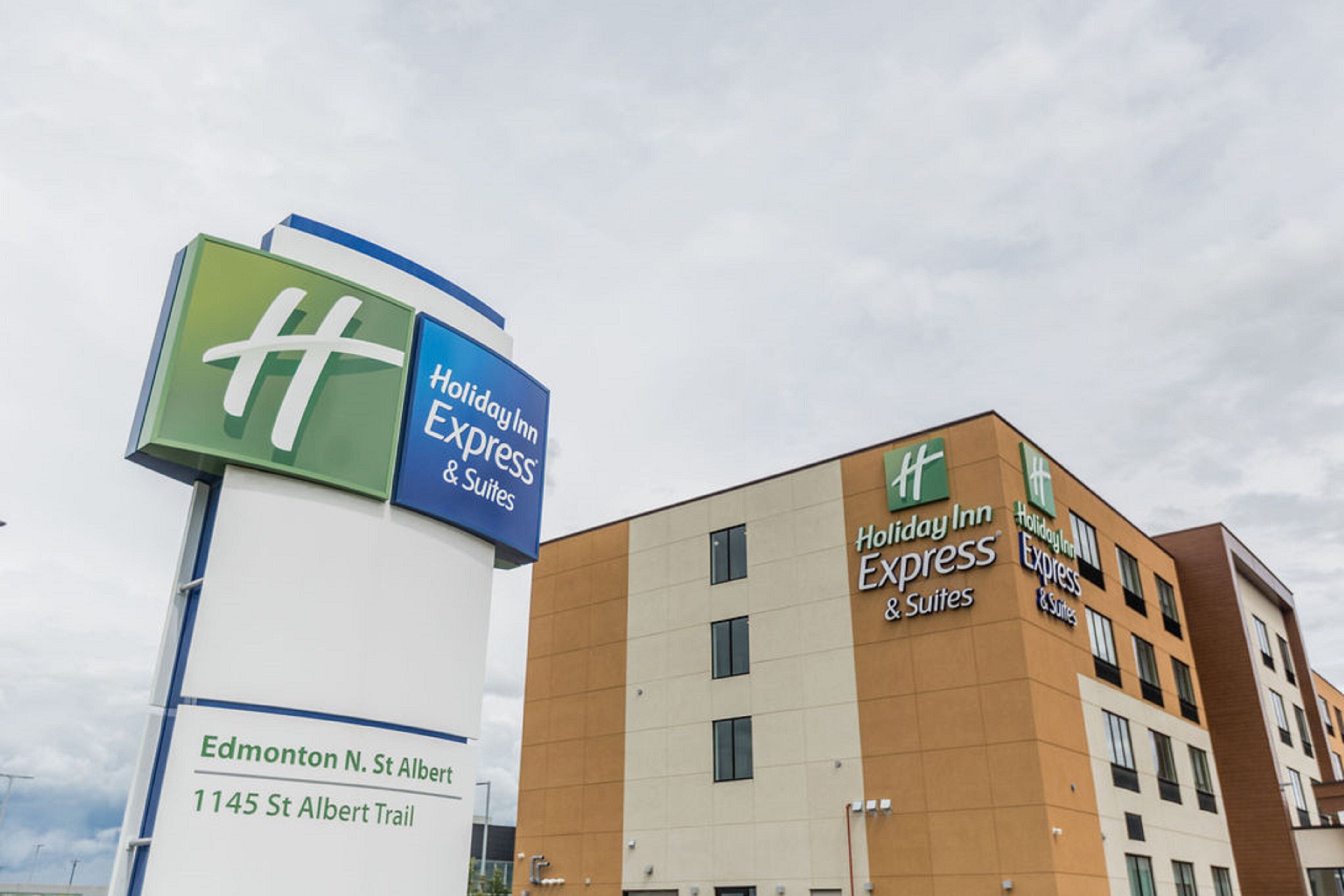 A Holiday Inn Express & Suites building with a prominent sign and multiple windows.
