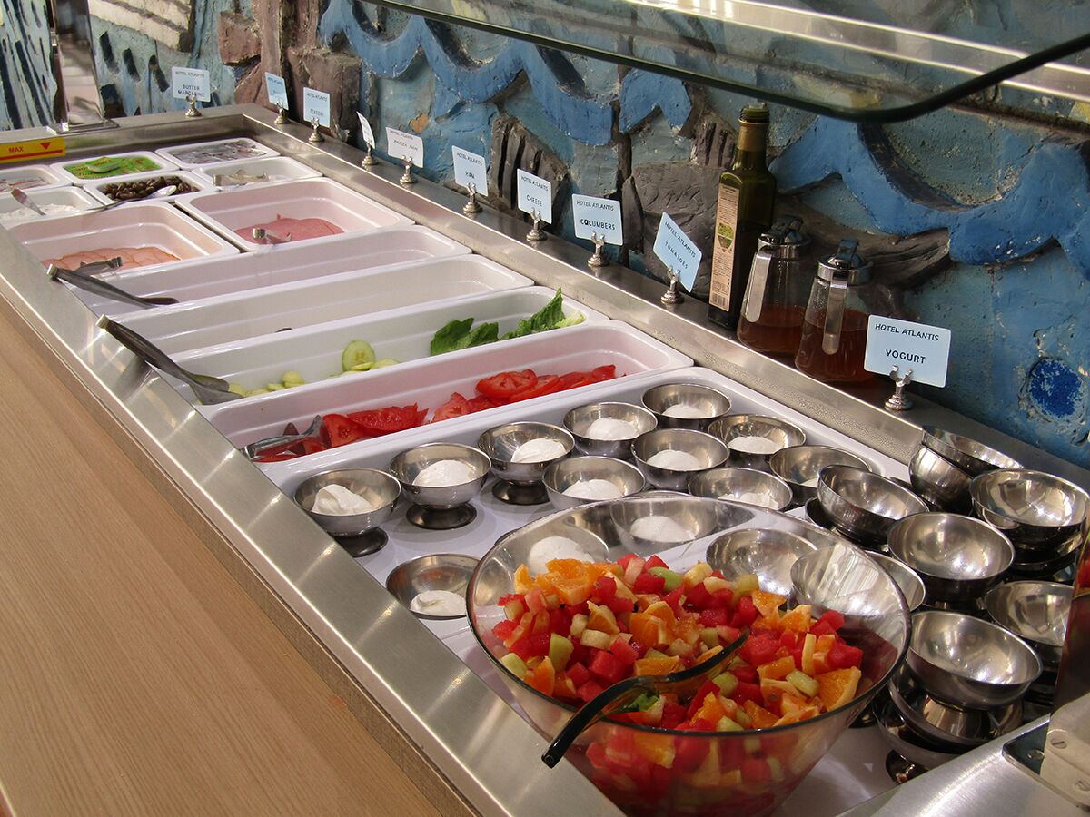 A buffet with various food options and condiments.