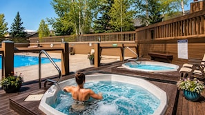 A spa area with two hot tubs, wooden deck, and a pool. - 1687 Lakeside 3 Bedroom Home by RedAwning (Park City)