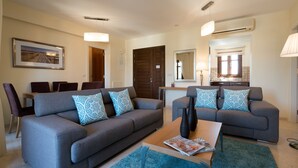 A modern living room with two sofas, a coffee table, and a dining area with chairs. - Apartment DD12 - Chloe (Kouklia)
