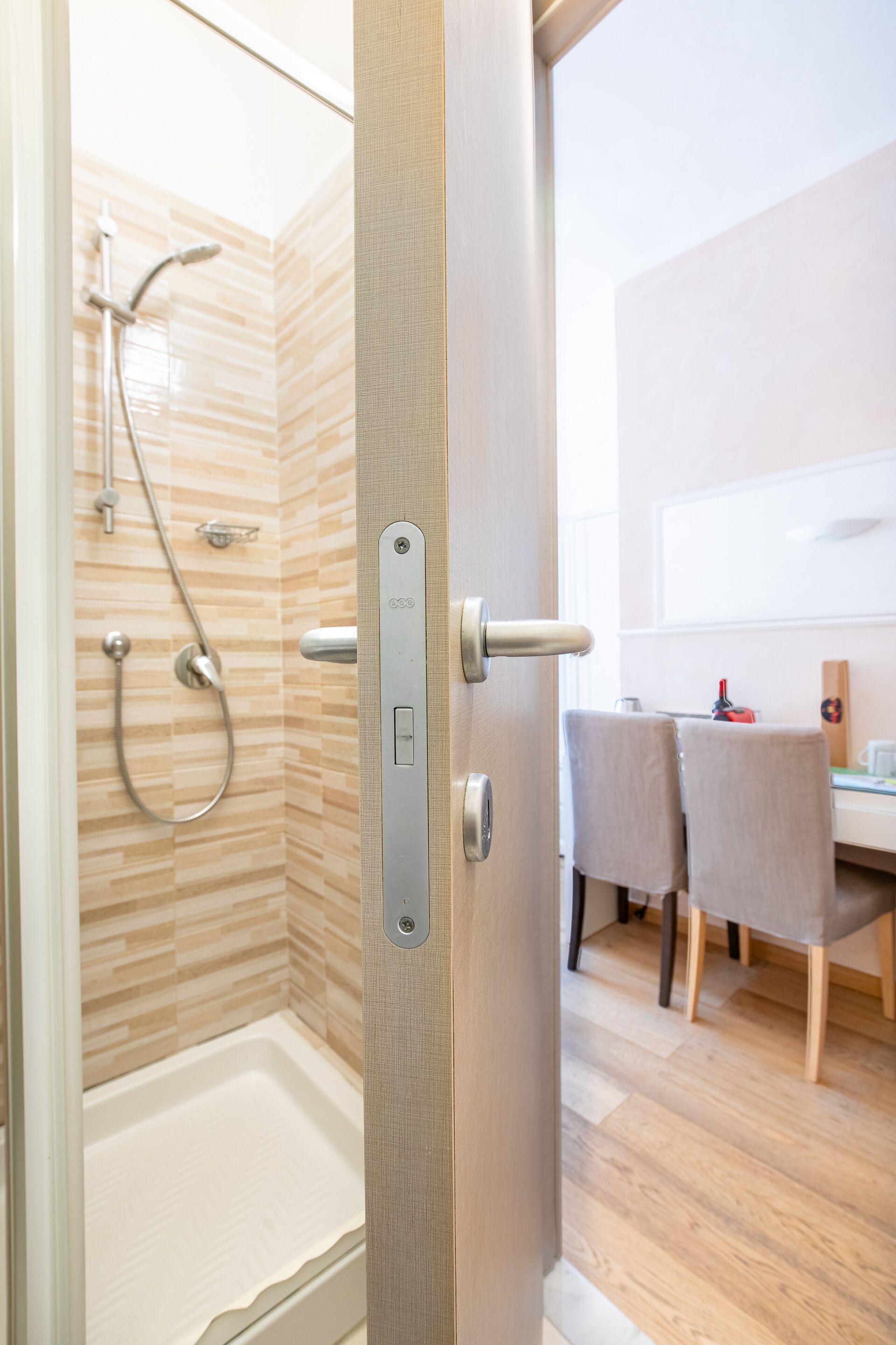 A modern bathroom with a shower, a toilet, and a sink.