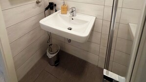 A bathroom with a white sink, mirror, and vanity.