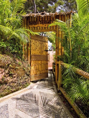 A bamboo archway leading to a wooden structure labeled 'Bamboo Serenity.' - Atma Villas Hotel Boutique Guatapé (El Peñol)