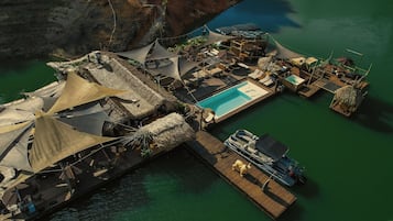 Relax on a floating platform surrounded by crystal-clear waters and stunning rock formations.