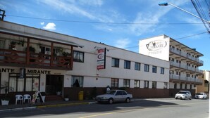 A hotel named 'Mirante' with a signboard, a reception area, and a car parked in front. - Hotel Mirante (Barra Velha)