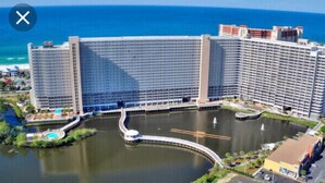Un grande hotel con diversi edifici a grattacielo, un cortile centrale e una vasca d'acqua.