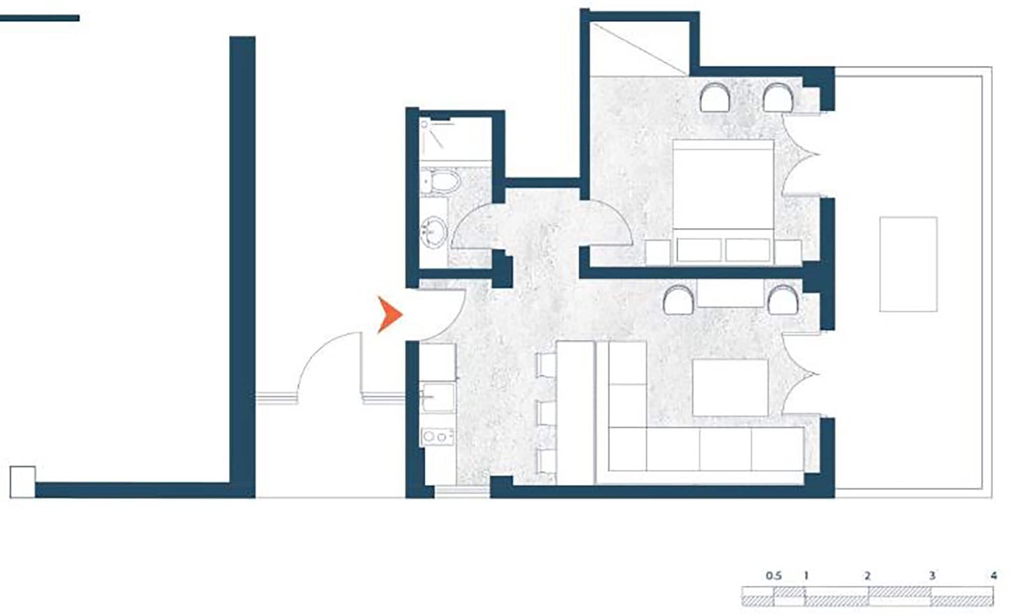 A floor plan of a hotel room with a bathroom, a kitchenette, and a seating area.