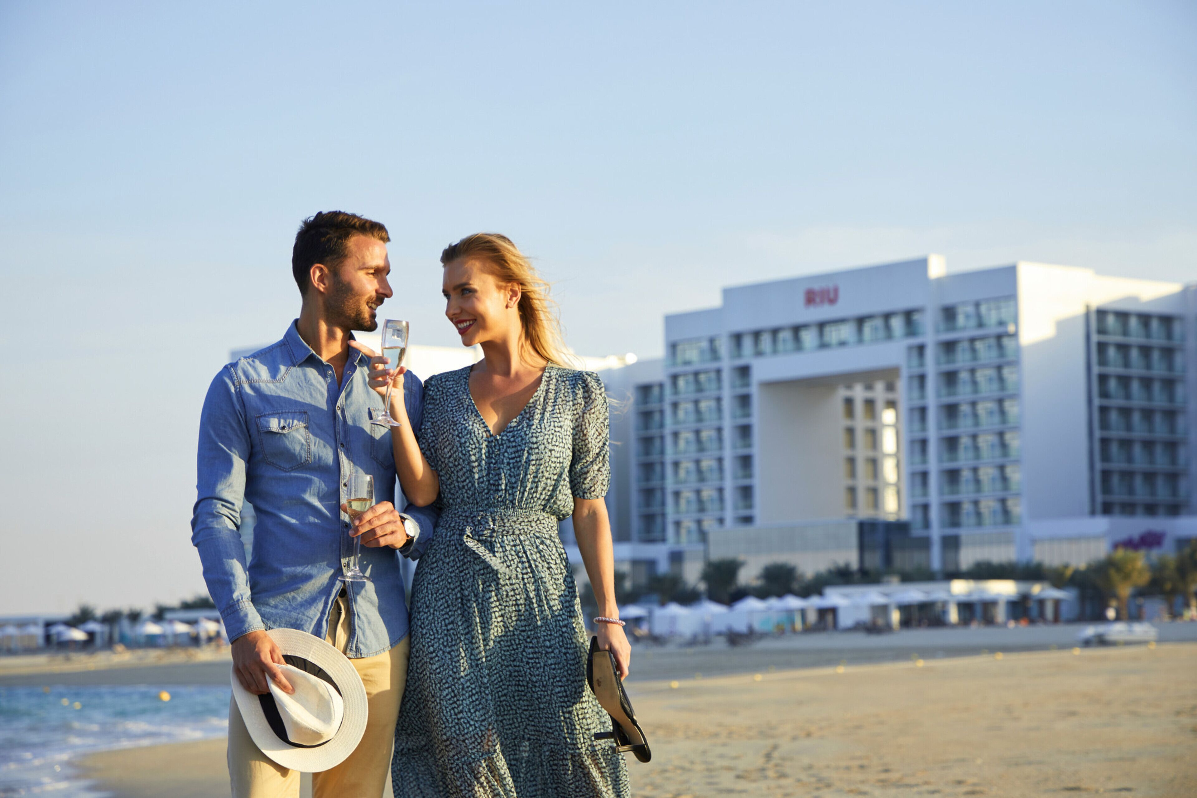 A beach scene with a hotel in the background.