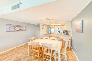 Enjoy meals in this dining area with a large table and six chairs, adjacent to a fully equipped kitchen.
