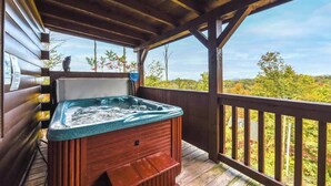 A hot tub on a wooden deck with a view of a forested landscape. - Amazing Views! Hot Tub,Pool Table,Fireplace,Relax! (Gatlinburg)
