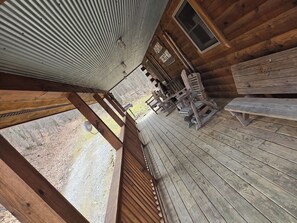 A wooden deck with benches and a picnic table, overlooking a gravel path and trees. - Holler Cabin 4 bedroom Hocking Hills-Tar hollow (price calculated per #  guests) (Laurelville)