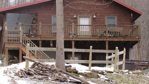 A rustic cabin with a wooden deck and a red roof. - Holler Cabin 4 bedroom Hocking Hills-Tar hollow (price calculated per #  guests) (Laurelville)