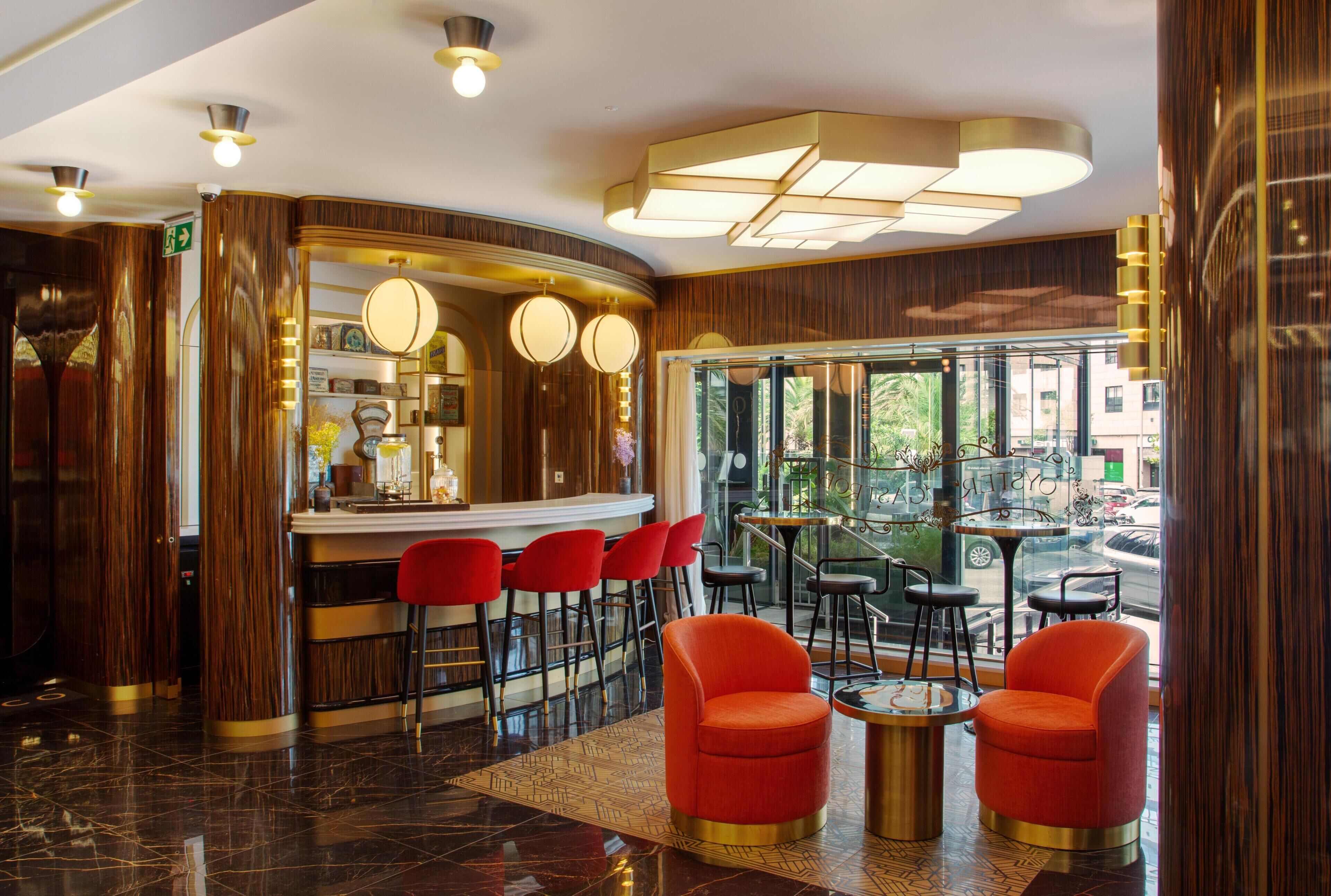 A bar area with red chairs and a counter, a glass door leading outside, and a patterned floor.