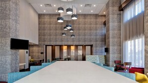 A conference room with a large table, multiple chairs, and a modern ceiling design. - Hampton Inn & Suites Deptford (Woodbury)