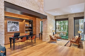 Enjoy a peaceful retreat with a dining table for four, a cozy seating area, and a large window offering a view of lush greenery.