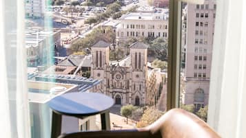 A modern room with a view of a cityscape, including a church and buildings.