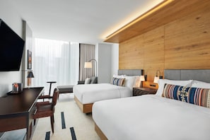 A hotel room with two beds, a desk, a chair, a TV, and a window with curtains. - Canopy San Antonio Riverwalk   (San Antonio)