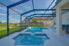 A covered outdoor swimming pool with lounge chairs and a view of the surrounding landscape. - balmoral Villa (Davenport)